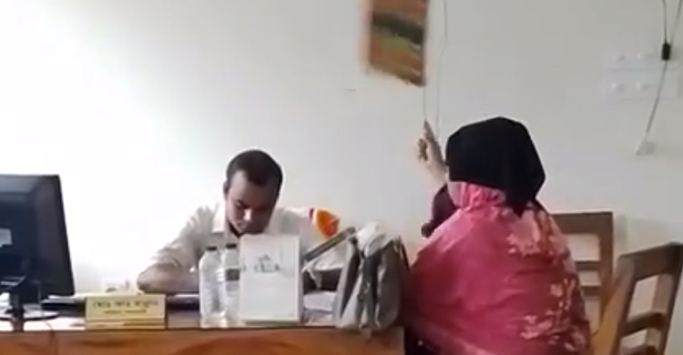 অফিসে খাচ্ছেন সরকারি কর্মচারী, বাতাস করছেন সেবা নিতে আসা নারী