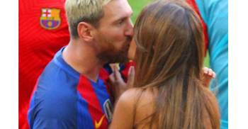 Messi gets a kiss from his adoring partner 