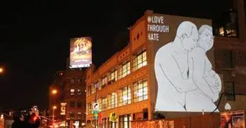 An image of Putin caressing a pregnant Trump projected on a store