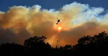 Firefighters battle blazes on two fronts in California, 50 dead