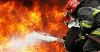 Woman dies as city building catches fire