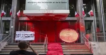 Protesters douse French health ministry with red paint
