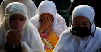 Indonesian Muslims perform Eid prayers with social distancing, masks