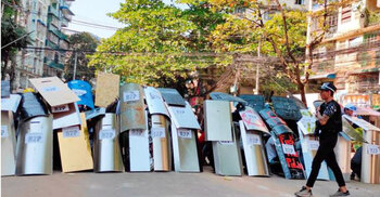 Myanmar forces make night raids after breaking up protests