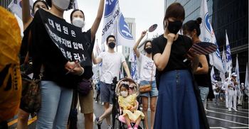 Thousands protest against Moon as Seoul scrambles curb virus resurgence