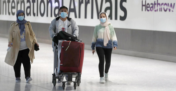 WHO urges travellers to wear masks as new COVID variant spreads