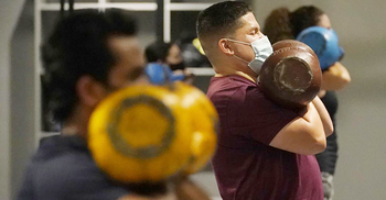 US hits 70% vaccination rate - a month late, amid a surge