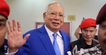 Malaysia halves ex-PM's jail term for corruption