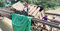ব্রিজে কাঠবোঝাই ট্রাক আটকে যোগাযোগ বন্ধ