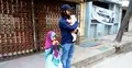 সাত মাসের সন্তান কোলে বাইরে বাবা, ভেতরে ভোট দিচ্ছেন মা